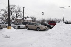 Thanks a lot! That, no doubt, is the sarcastic sentiment felt by the owners of the cars Friday in the municipal lot across Newton Avenue from U.S. Bank and Wells Fargo.  They were trapped between a snow pile and other cars. At first glance, people might blame a snowplow operator. Actually, the pile of snow was there first. The people to blame are the drivers who parked in back, trapping the ones in the middle for the duration of the workday. Perhaps the ones in back need a little bit more coffee in the morning to help them be observant.