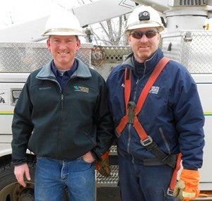 Loren Sprague and Al Casterton stand in front of the Freeborn Mower bucket truck. --Submitted