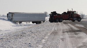 A tow truck for big rigs turns around on westbound Interstate 90 this morning as it gets ready to remove a semi and a compact car from the ditch. -- Tim Engstrom