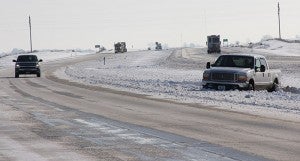 Just past the Faribault County line on Interstate 90 people await rescue in a Ford pickup that had ended up in the median Wednesday morning. -- Tim Engstrom/Albert Lea Tribune