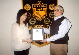 Albert Lean Stephanie Sherman, left, recently accepted the Service to Mankind Award from Albert Lea Sertoma Club President Ron Sorenson. --Submitted