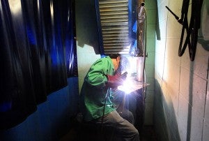 A high school student works on an arc weld Friday at Riverland Community College in Albert Lea.