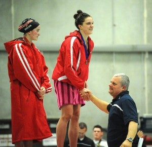 Lindsey Horejsi of Albert Lea shakes hands with her coach, Jon Schmitz, after he presented her with the first-place medal for winning the 200-yard individual medley in 2:05.83. — Micah Bader/Albert Lea Tribune   