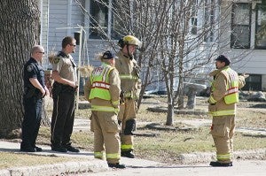 Members of the Albert Lea Fire Department, Albert Lea Police Department and Freeborn County Sheriff’s Office talk Tuesday after evacuating about eight homes on Fifth Street after a portion of the road caved in. – Sarah Stultz/Albert Lea Tribune