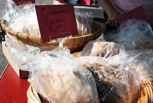 Jennifer Lomack of Austin sells several varieties of artisan bread, including cinnamon raisin and garlic tomato basil. – Tribune file photo