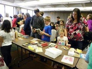 Children and parents pick out free books. — Provided
