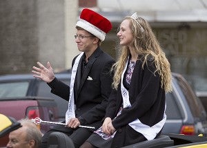 The 2014 Homecoming King Connor Larson and Queen Anna Englin ride in the parade Thursday in downtown Albert Lea. — Colleen Harrison/Albert Lea Tribune